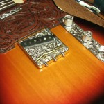 custom Telecaster with hand-engraved parts, hand-tooled leather pickguard